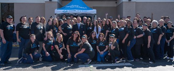 Here's an alt tag for the image: `Smiling group at Meritsy Heart event`