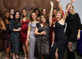 Group of women in formal dresses.