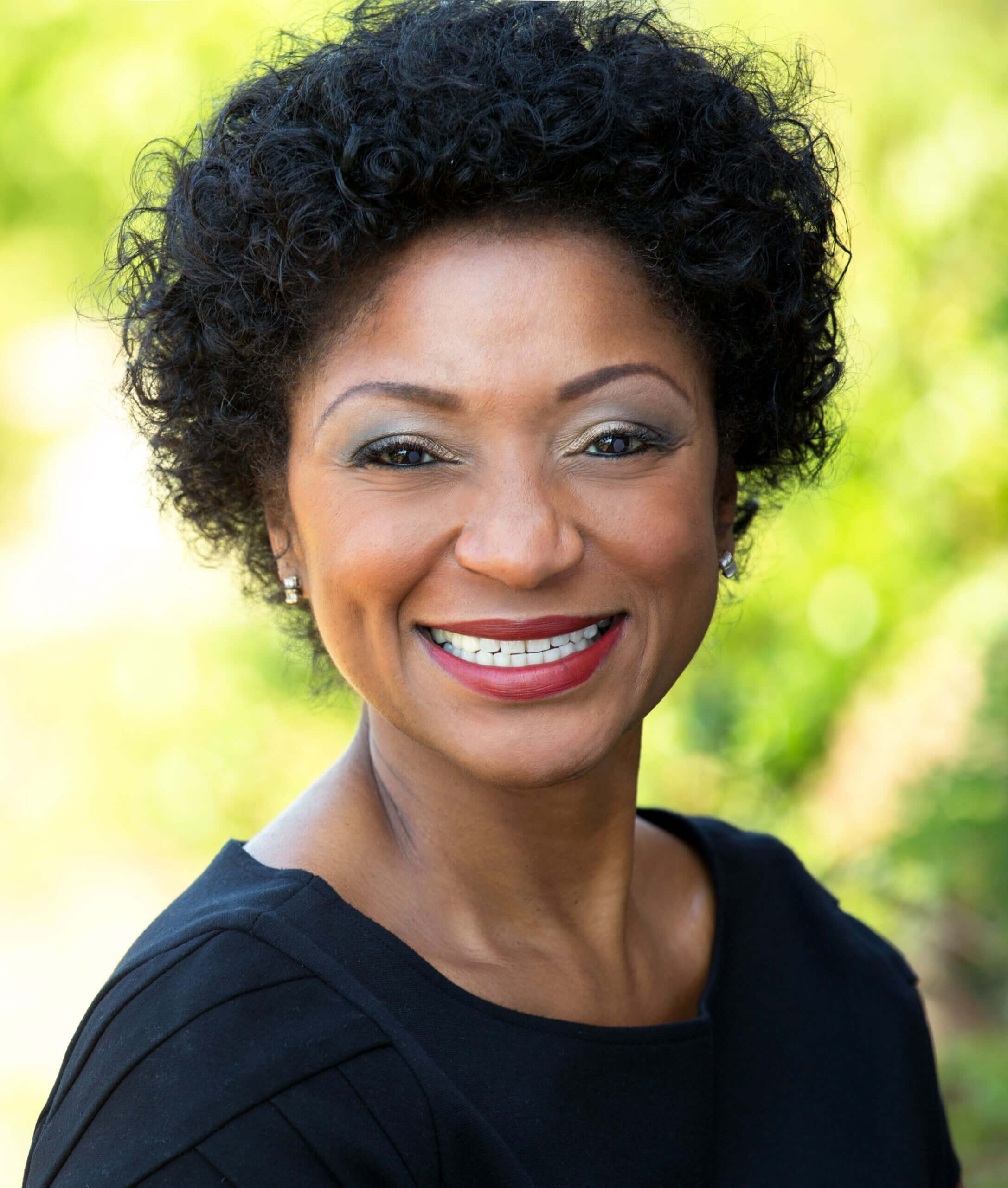 Smiling Black woman with curly hair. Smiling Black woman with curly hair.